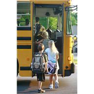 children getting on school bus