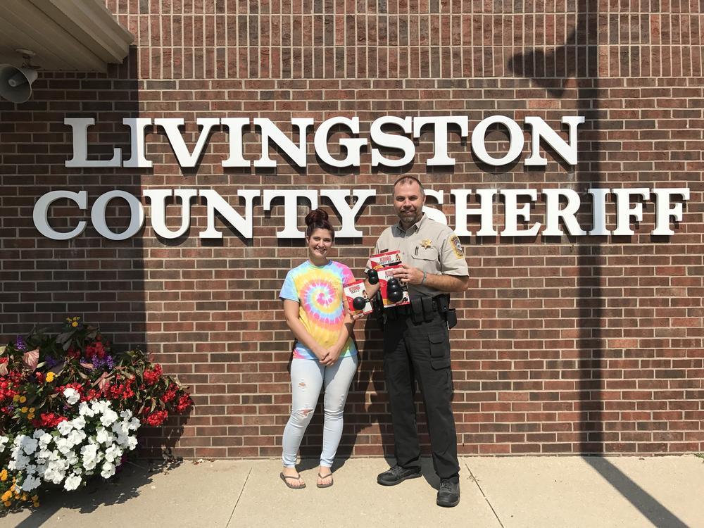 deputy mueller with woman in front of sheriff's office