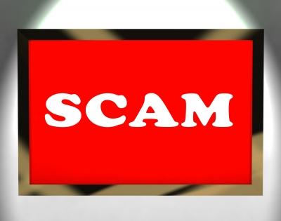 SCAM on red background