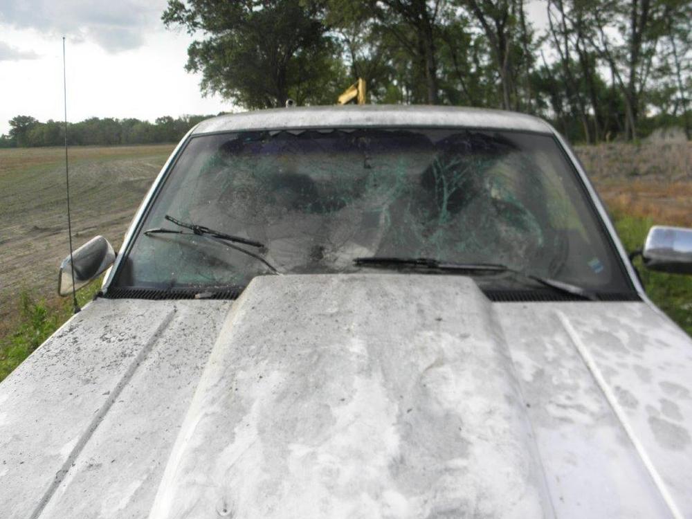 damaged hood of white truck