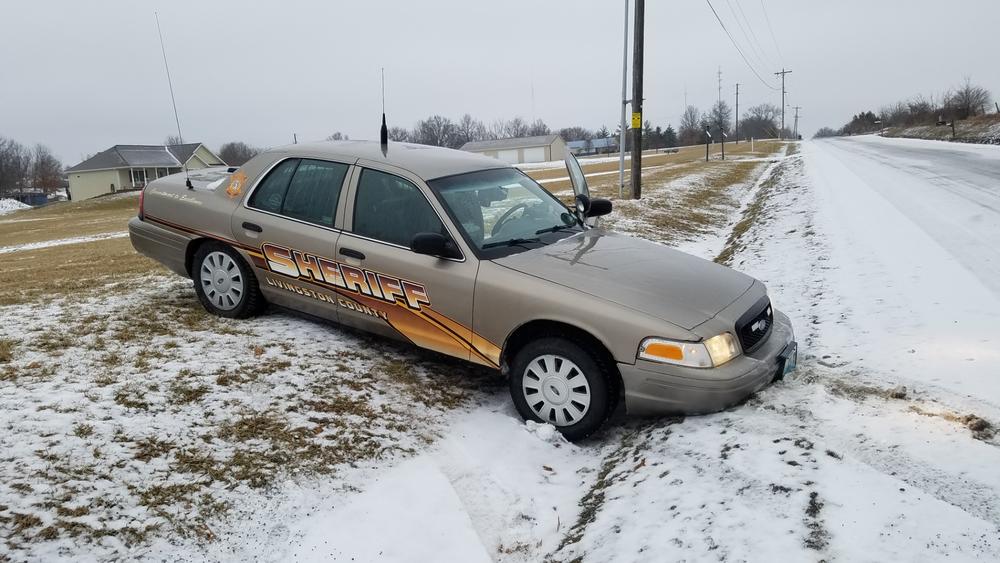 deputy car in snowy ditch